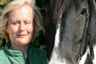 woman looking at a horse