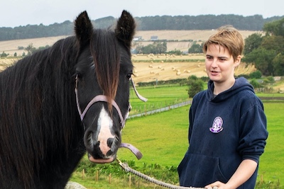 woman looking at a horse