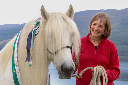 proud owner leading her newly rehomed horse